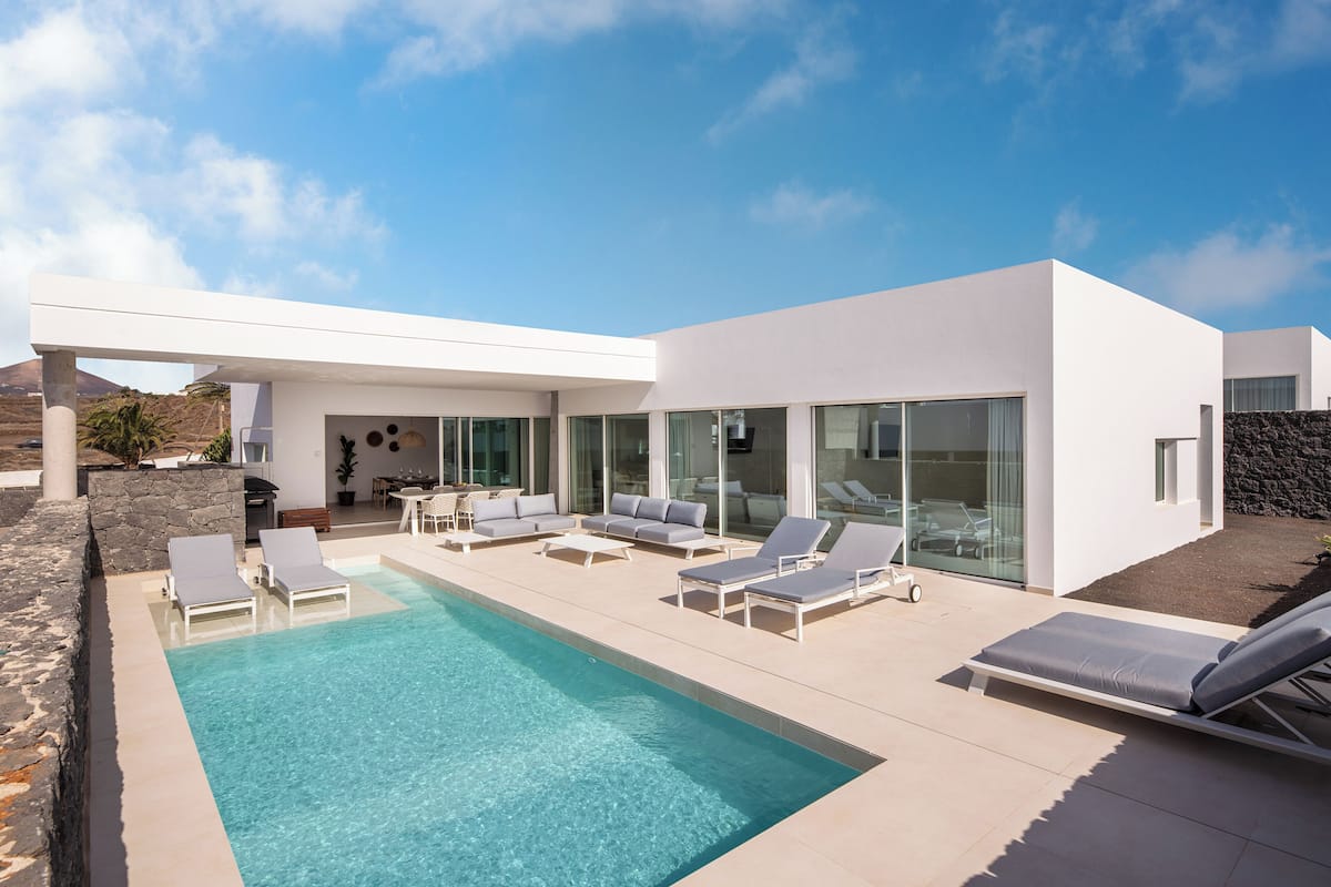 A modern pool area with lounge chairs and a clear pool.