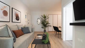 Design Apartment, City View | Living area | 50-inch TV with cable channels