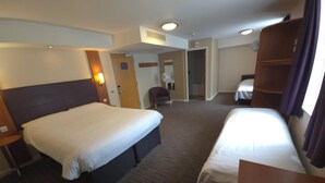 A hotel room with two beds, a desk, a chair, and a wardrobe. - Charter Hotel Bournemouth (Bournemouth)