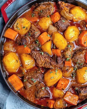 A close-up of a beef stew with carrots and potatoes. - Royal Green Gardens (Nakuru)