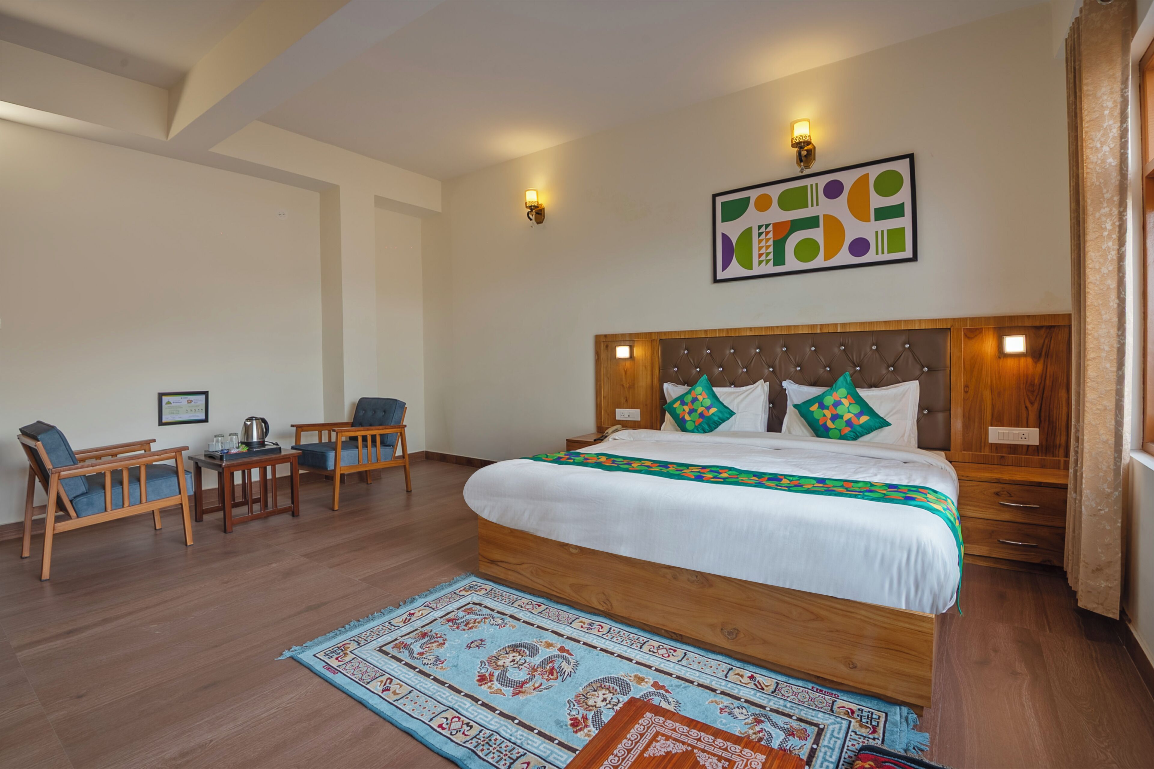 A bedroom with a wooden bed, two bedside tables, a chair, a small table, and a decorative rug.