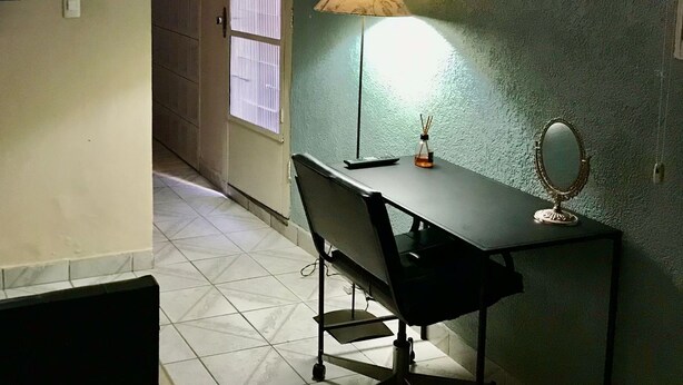A room with a desk, chair, lamp, and a mirror. - Cozy little house in São Paulo, your home away from home!!  Easy access (Unknown)