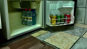 An open refrigerator with beverages and cans inside. - Cozy little house in São Paulo, your home away from home!!  Easy access (Unknown)