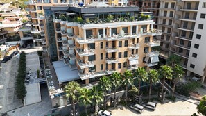 A multi-story hotel with balconies, a bar, and a restaurant.