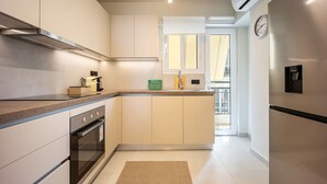 A modern kitchen with a built-in oven, a microwave, and a sink.