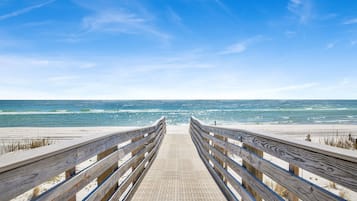 Walk along the boardwalk to the sandy beach with a clear view of the ocean.