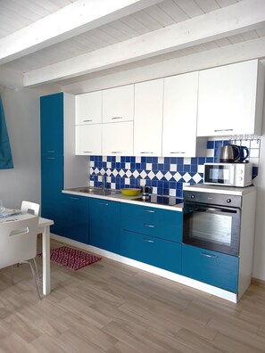 Enjoy cooking in this well-equipped kitchen with an oven, microwave, and sink.