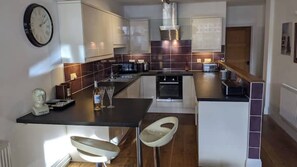 Enjoy cooking in this well-equipped kitchen with a central island, oven, and stovetop.