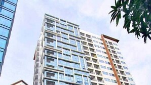 Un hôtel de grande hauteur, doté de nombreux étages, d’une architecture moderne et d’un hall d’entrée abrité.