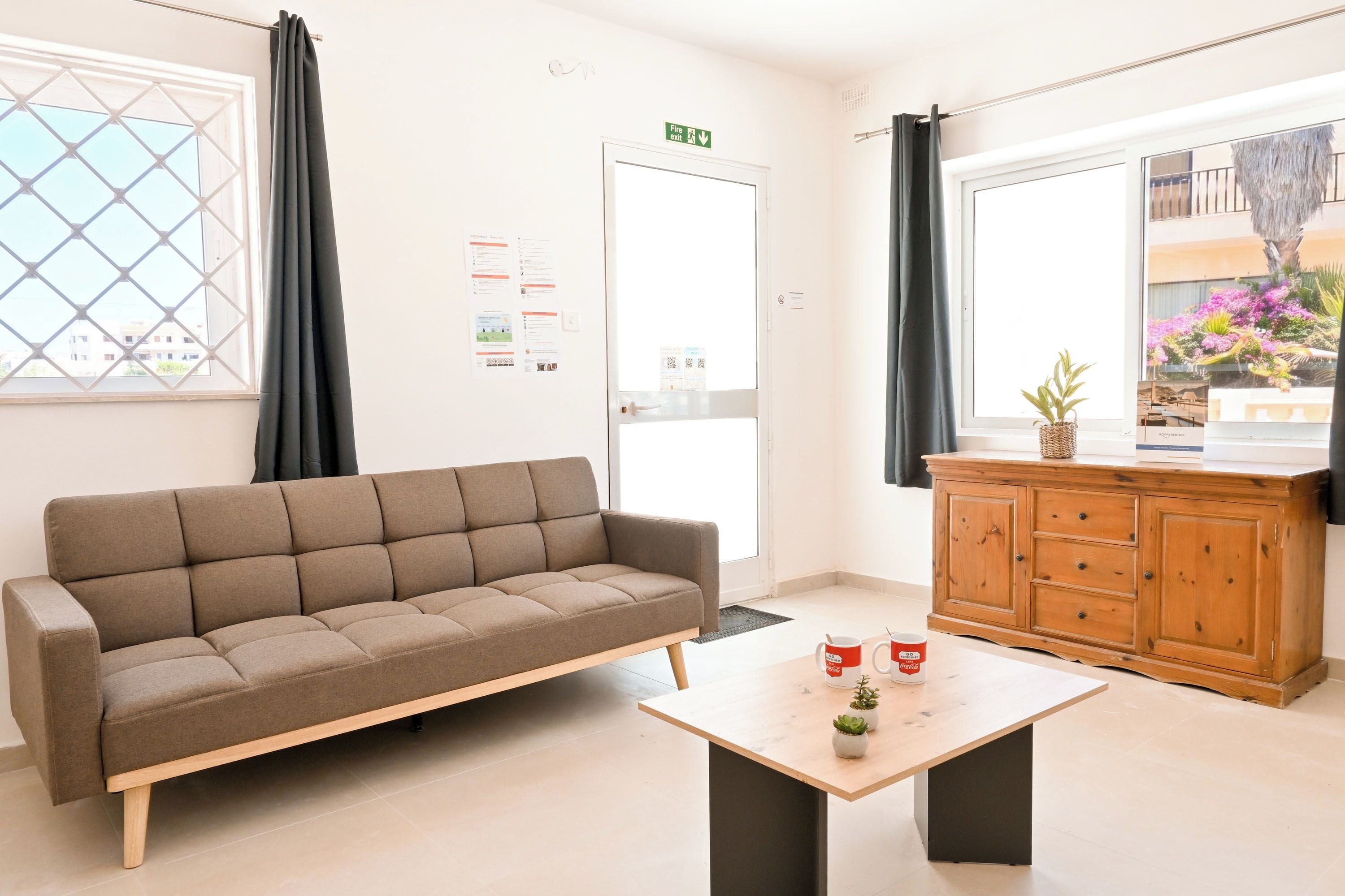 A modern living room with a sofa, a wooden cabinet, and a coffee table.