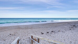 A sandy beach with a wooden walkway leading to the water. - Ocean Access, Mini Golf & Pools: Jensen Beach Gem (Jensen Beach)