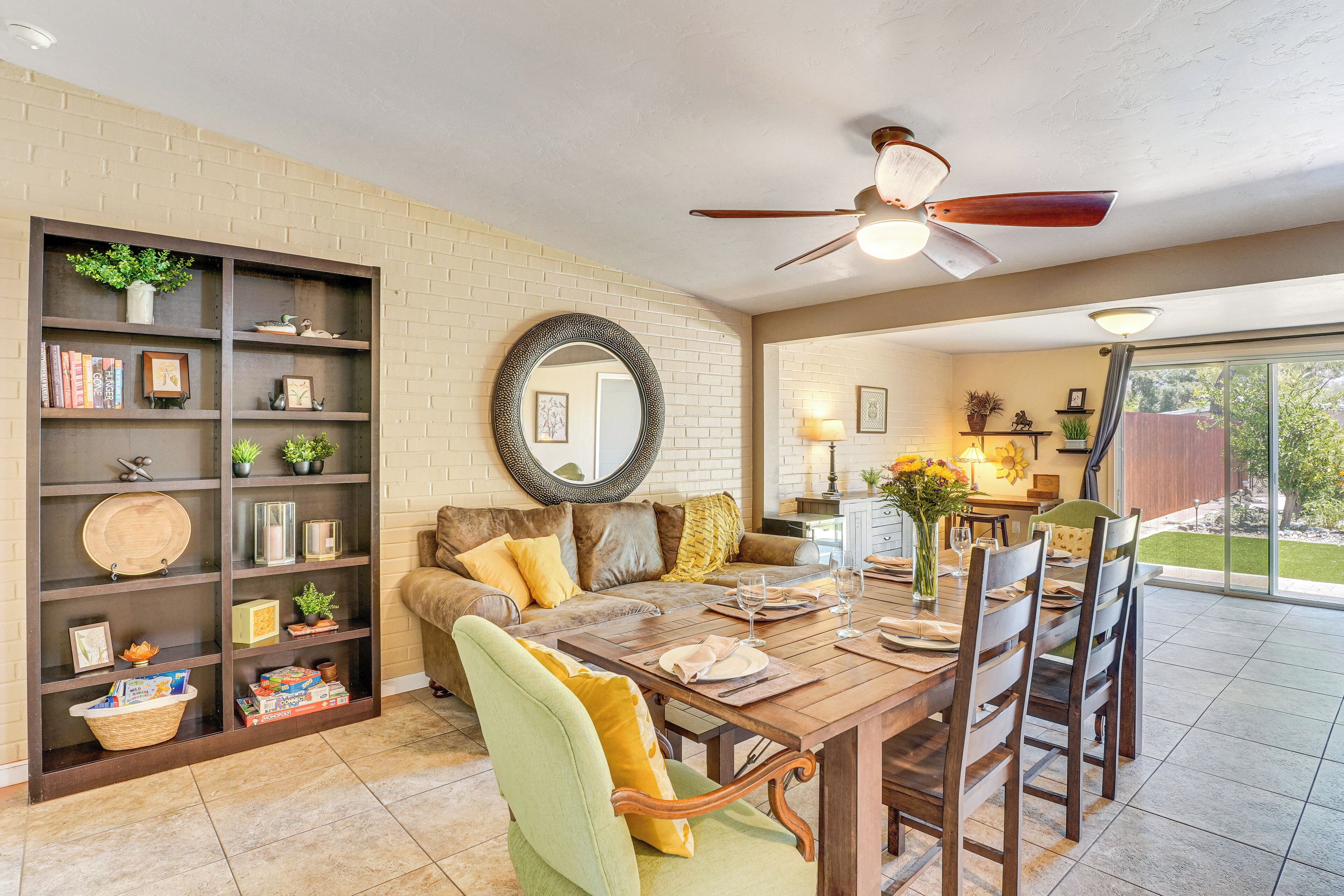 A dining area with a wooden table, chairs, and a bookshelf.