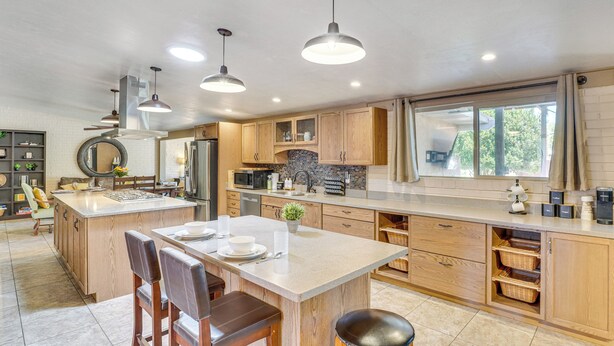 A spacious kitchen with a large island, wooden cabinets, and pendant lighting. - Dog-Friendly Getaway w/ Patio in Tucson! (Tucson)