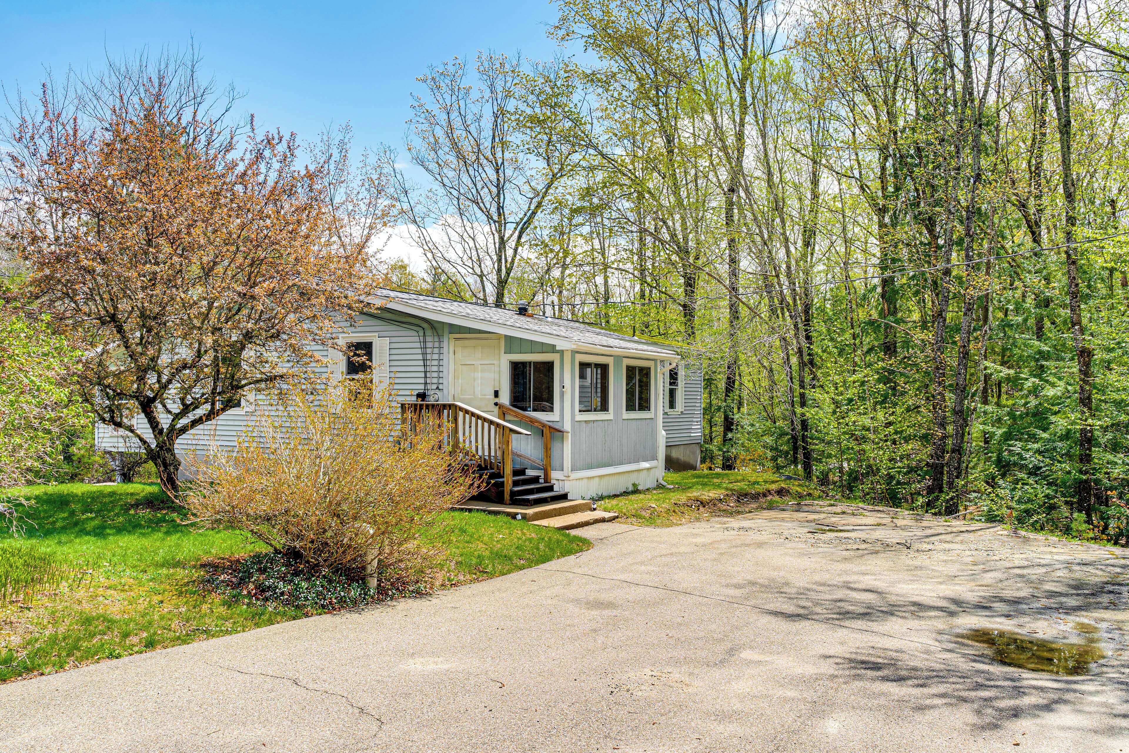 A single-story mobile home with a front porch and a small staircase leading to the entrance.