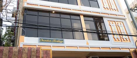 A multi-story building with a sign reading "Chandan Heritage."