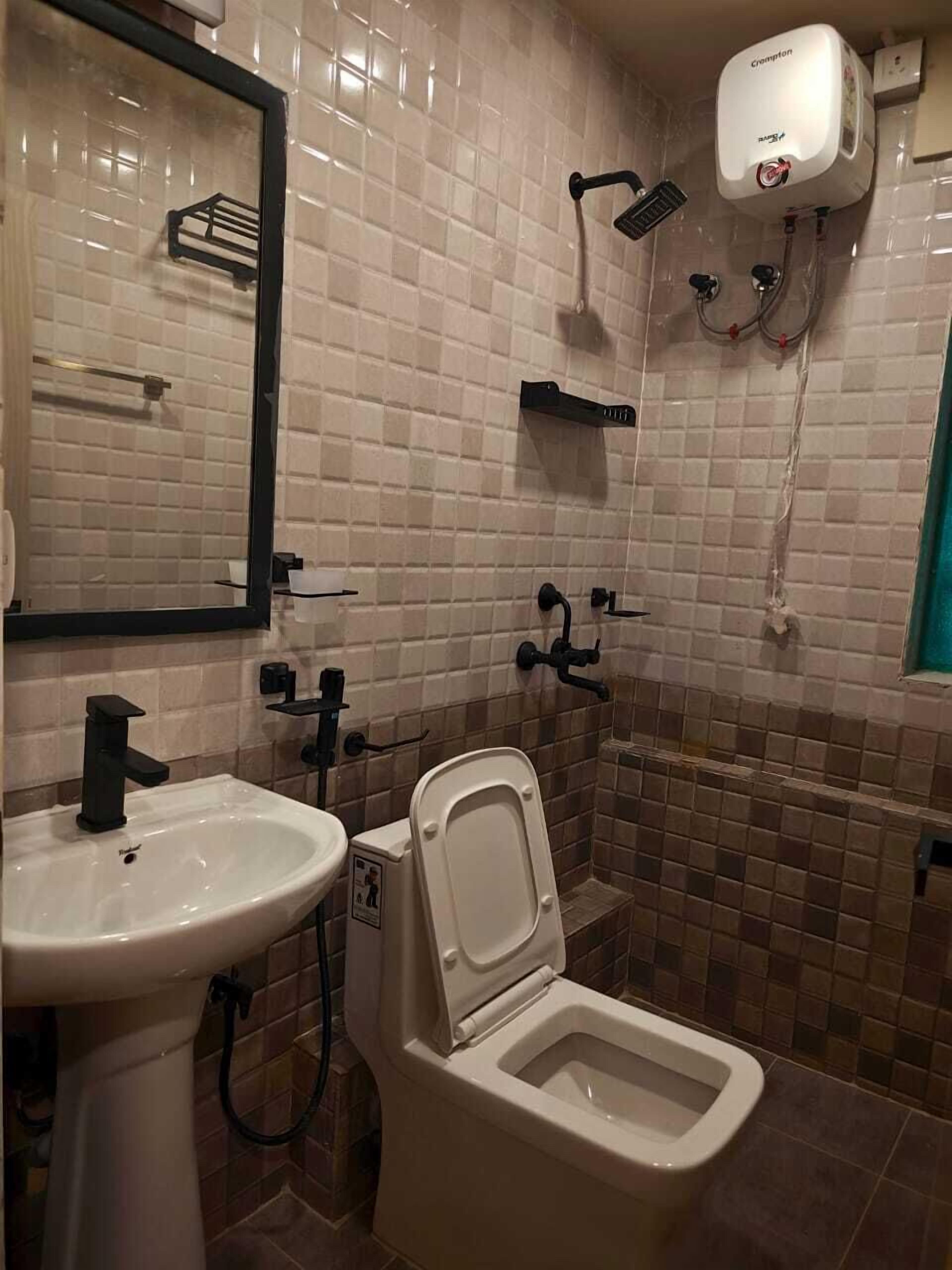 A bathroom with a sink, toilet, and shower.