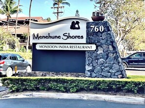 A sign for Monsoon India Restaurant at Menezhu Shores, featuring a stone pillar with the number 760. - FALL SPECIAL!! PREMIUM OCEANFRONT UNIT WHER THE OCEAN MEETS THE SKY!!! (Kihei)