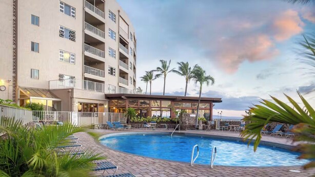 A hotel with a swimming pool, lounge chairs, and palm trees. - FALL SPECIAL!! PREMIUM OCEANFRONT UNIT WHER THE OCEAN MEETS THE SKY!!! (Kihei)