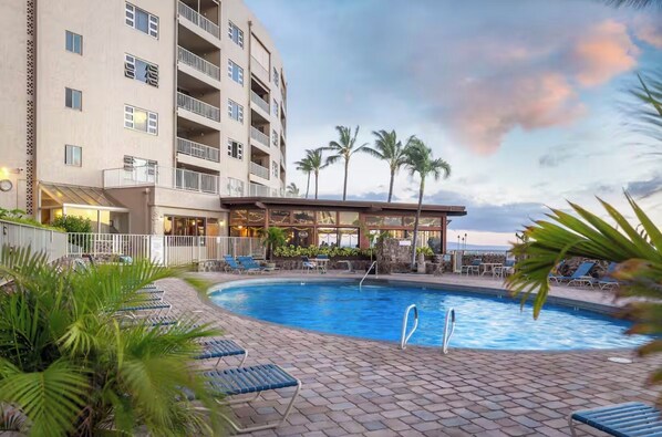 A hotel with a swimming pool, lounge chairs, and palm trees. - FALL SPECIAL!! PREMIUM OCEANFRONT UNIT WHER THE OCEAN MEETS THE SKY!!! (Kihei)