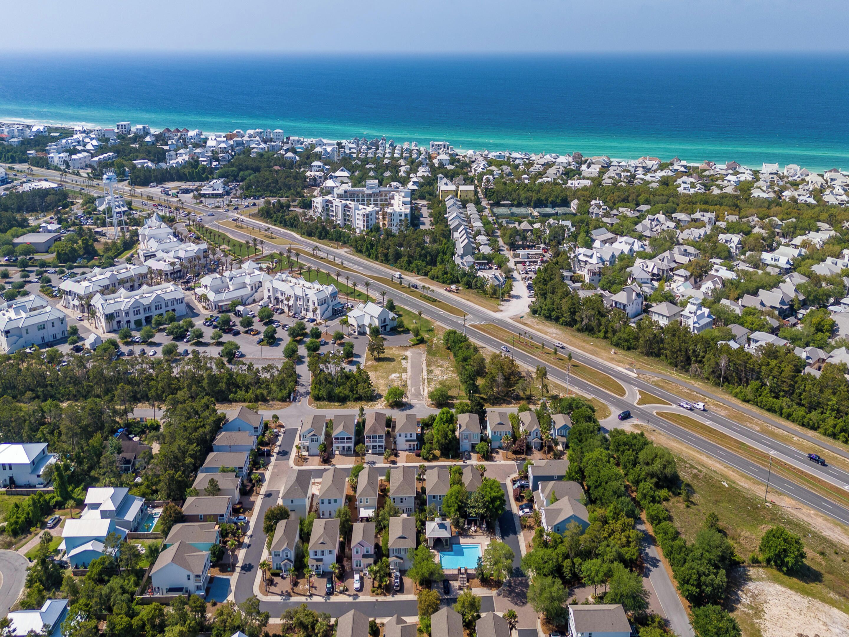 Luchtbeeld van een kustgebied met huizen, wegen en een strand.