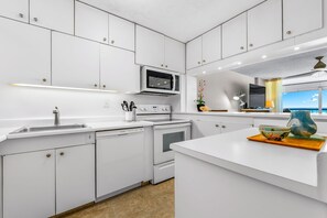 Enjoy cooking in this well-lit kitchen with a microwave, dishwasher, and large island.