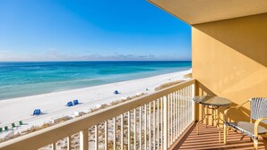 A balcony with a view of a beach and ocean. - Pelican Beach 0602 1 Bedroom Condo (Destin)