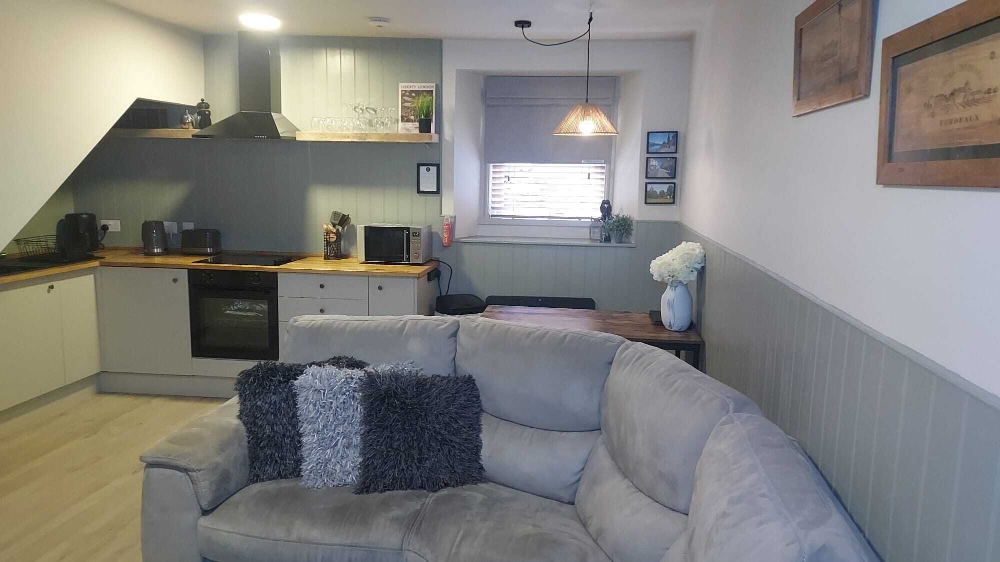 Relax on the corner sofa with plush cushions.