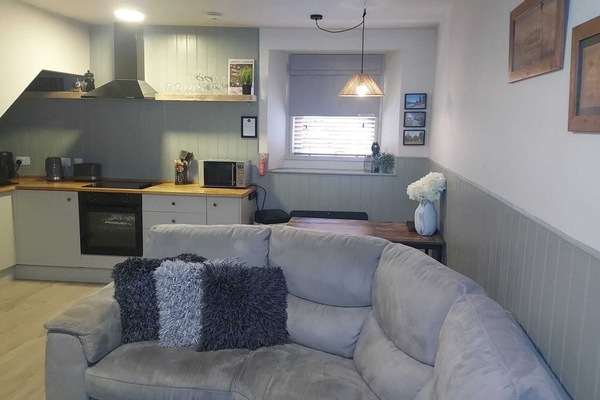 Relax on the corner sofa with plush cushions.