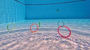 An underwater view of a swimming pool with four rings on the floor. - Banana Resort le Petit nid de Caro (Siem Reap)