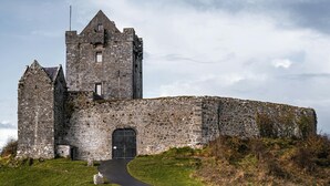 A historic stone castle with a prominent tower, a large arched entrance, and a surrounding stone wall. - Bed & Breakfast, Stoneywood Haven in Galway, Clarinbridge (Galway, Clarinbridge)