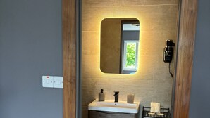 A modern bathroom with a wooden vanity, a mirror, and a towel rack. - Bed & Breakfast, Stoneywood Haven in Galway, Clarinbridge (Galway, Clarinbridge)