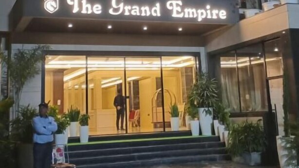 A hotel entrance with a sign reading "The Grand Empire." - Hotel Grand Empire (Agra)