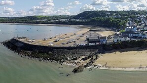 An aerial view of a coastal town with a sandy beach, a rocky breakwater, and a marina with boats. - Yr Onnen, Aberaeron - Two Bedroom Cottage, Sleeps 4 (Llanarth)