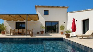 A swimming pool with a patio area, outdoor furniture, and potted plants. - Villa in Ménerbes in the Luberon golden triangle (Ménerbes)
