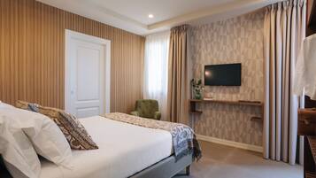A bedroom with a bed, a television, a chair, and a shelf.