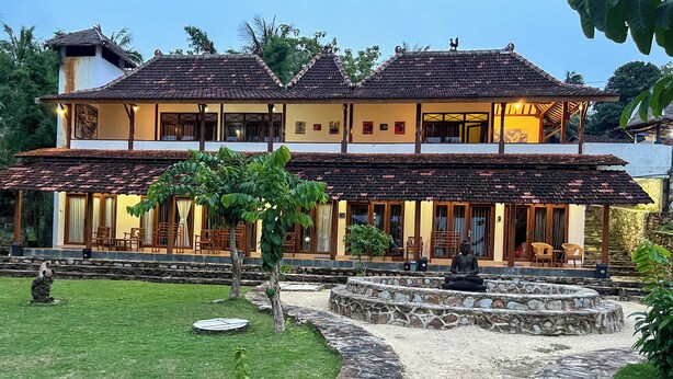 A two-story building with a tiled roof and a stone pathway leading to the entrance. - Arys Lagoon Resort Karimunjawa (Karimunjawa)
