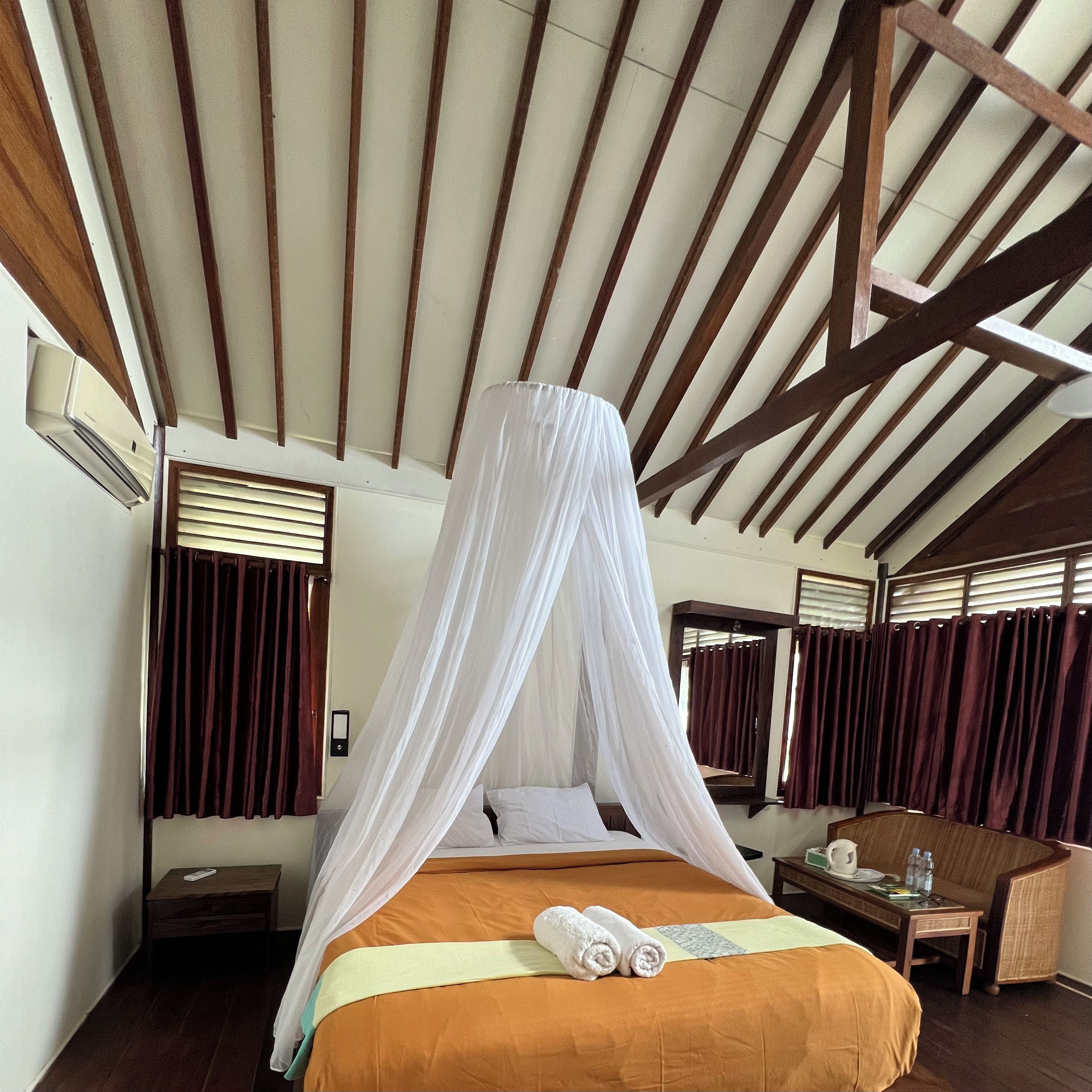 A room with a bed, a table, and a chair.