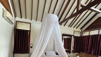 A room with a bed, a table, and a chair.
