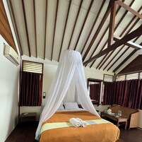 A room with a bed, a table, and a chair.