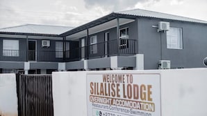 A two-story building with a signboard advertising Silalise Lodge as overnight accommodation. - Silalise Lodge (Greater Tubatse)
