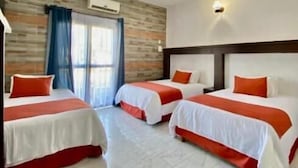 A hotel room with three beds, a wooden wall, a window with curtains, and a tiled floor. - HOTEL PINEDA REAL  (Tonalá)