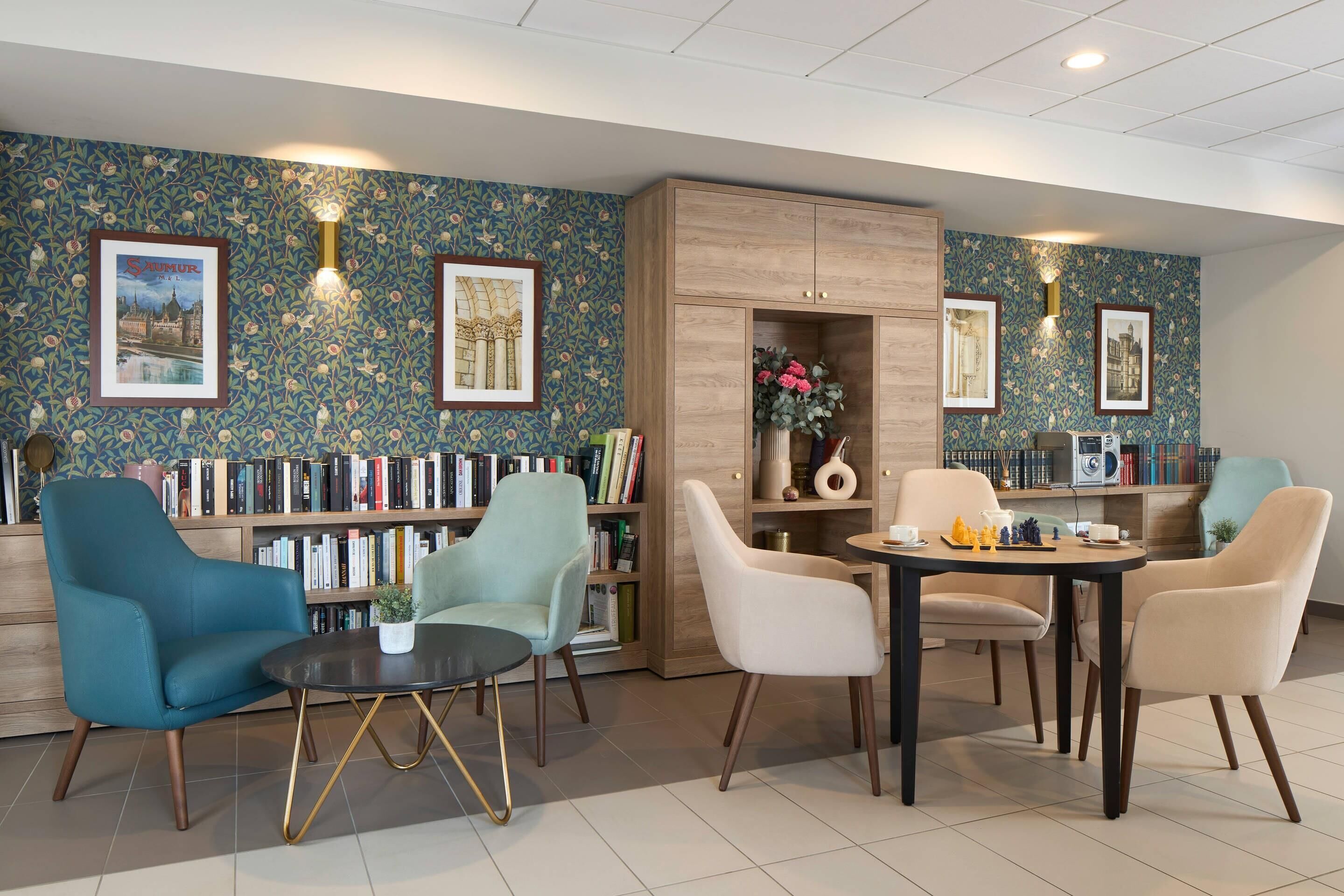 A modern lounge area with a bookshelf, seating, and a coffee table.