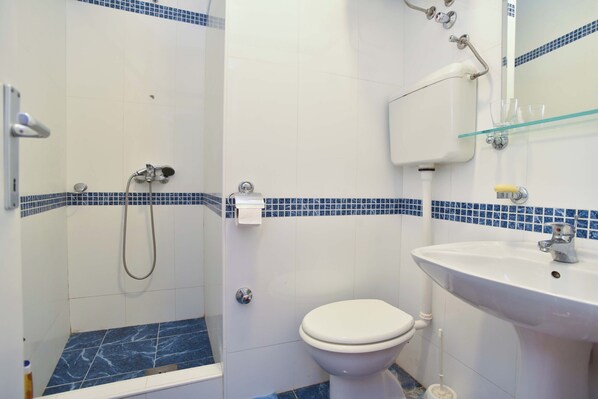 A bathroom with a shower, toilet, and sink. - PERFECT LOCATION IN BUDVA'S OLD TOWN (Budva)
