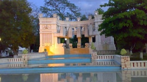A large, ornate building with multiple levels and a reflective water feature in front. - Casa Azalea in Garcia Ginerés near Downtown (Merida)