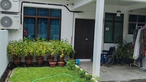 A residential area with a well-maintained lawn, potted plants, and a covered porch. - 
TSA Yasmin House, Kuah, Langkawi, Kedah Malaysia (Langkawi)