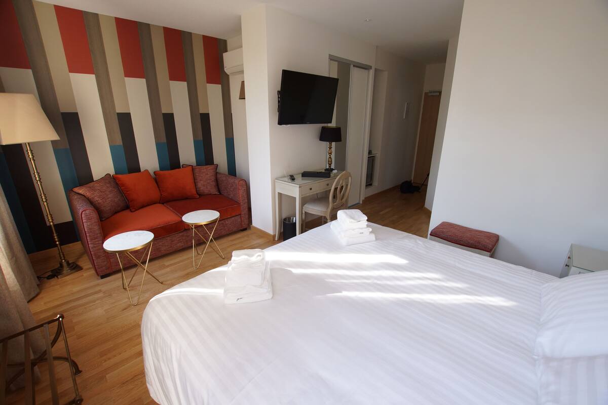 Superior Quadruple Room | Minibar, in-room safe, laptop workspace, blackout drapes