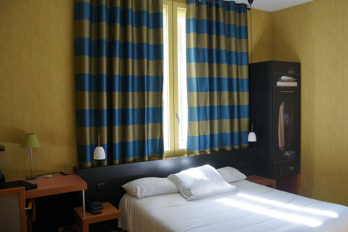 Superior Triple Room | Minibar, in-room safe, laptop workspace, blackout drapes