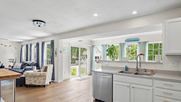 A modern kitchen with white cabinets, a dishwasher, and a sink. - Spacious 4-bedroom Single home in Ocean View with large outdoor spaces and Pool! (Ocean View)