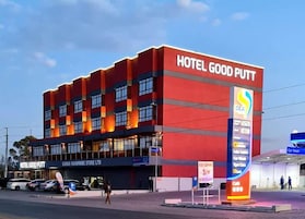 Un edificio de varios pisos con un letrero llamativo que dice "HOTEL GOOD PUTT".