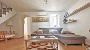 A spacious living area with a sofa set, a coffee table, and a staircase. - CERRO LUNA HOUSE (Constantina)